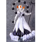 Detailed figurine of a character with white and black attire, holding a staff and surrounded by black spheres on a gray background.