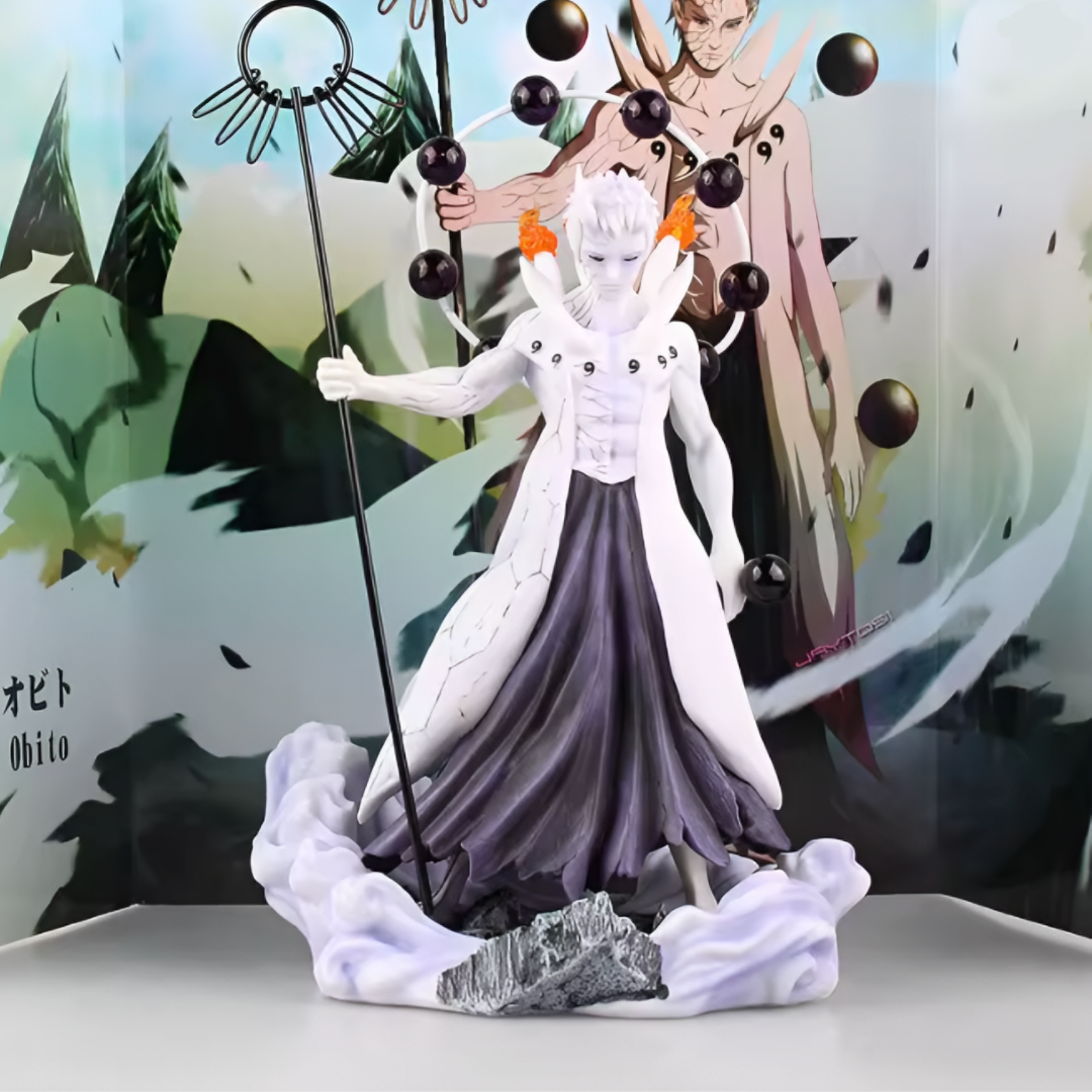 Anime character figurine with a staff and purple outfit against a blurred background